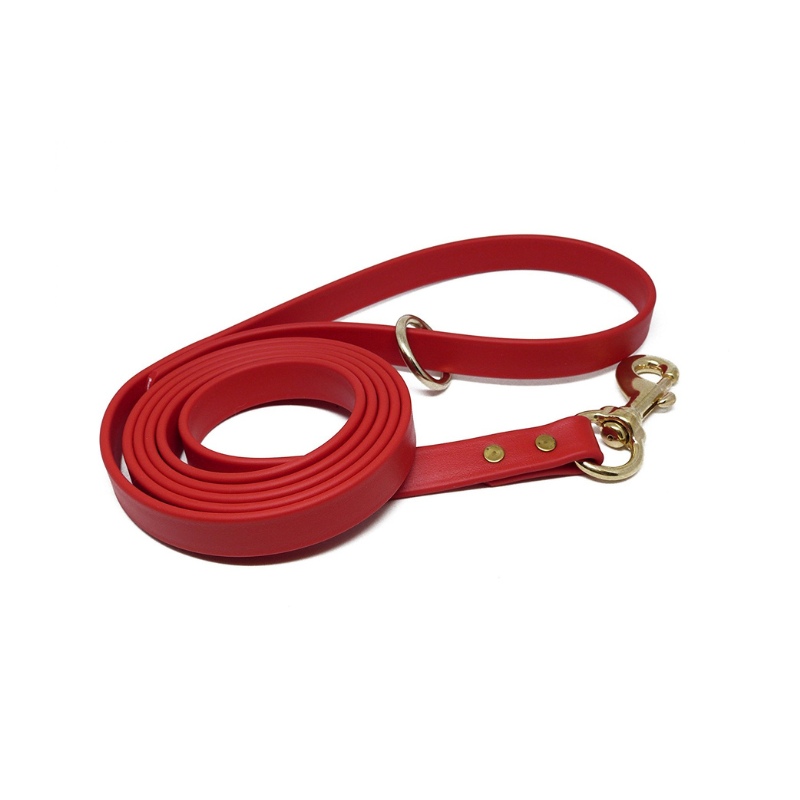 Red Biothane dog leash with brass snap hook and D-ring, waterproof, odorproof, and durable for training, walking, and outdoor use.