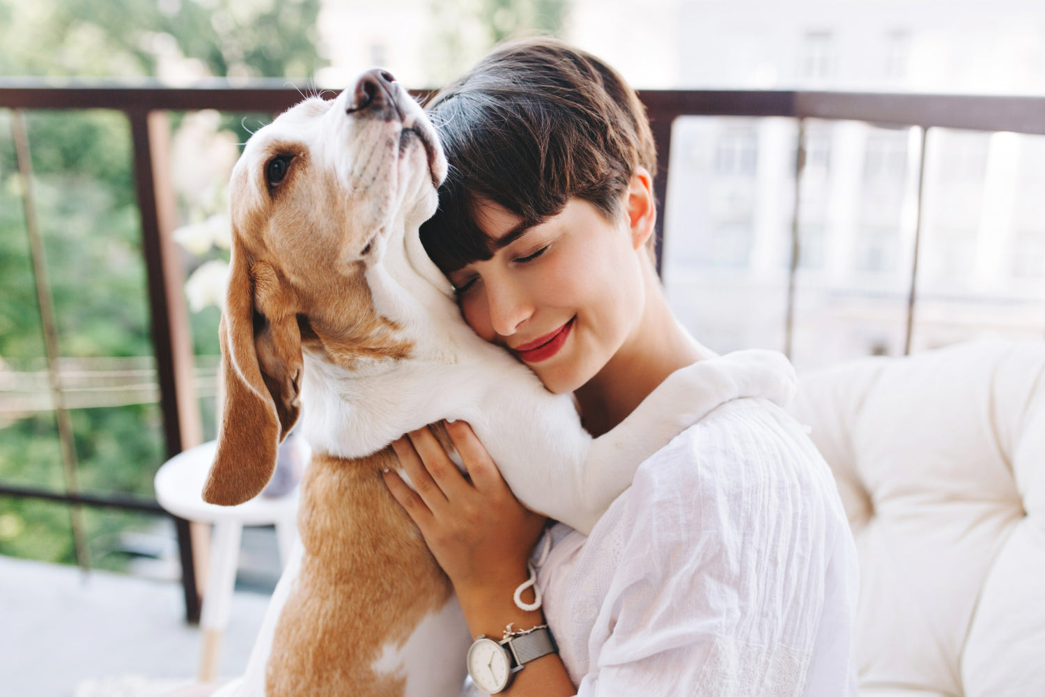 Happy woman hugging her dog outdoors — loving bond between pet and owner representing trust, care, and positive dog training with Jim Hodges Dog Training.