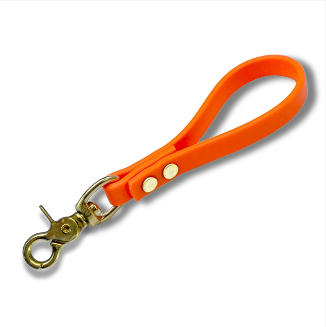 Orange Biothane dog training pull tab with premium brass snap hardware for obedience training, recall work, and off-leash dog control. Durable waterproof K9 pull tab leash designed for behavior correction, professional dog training, and everyday handling with strong rivets and comfortable grip.