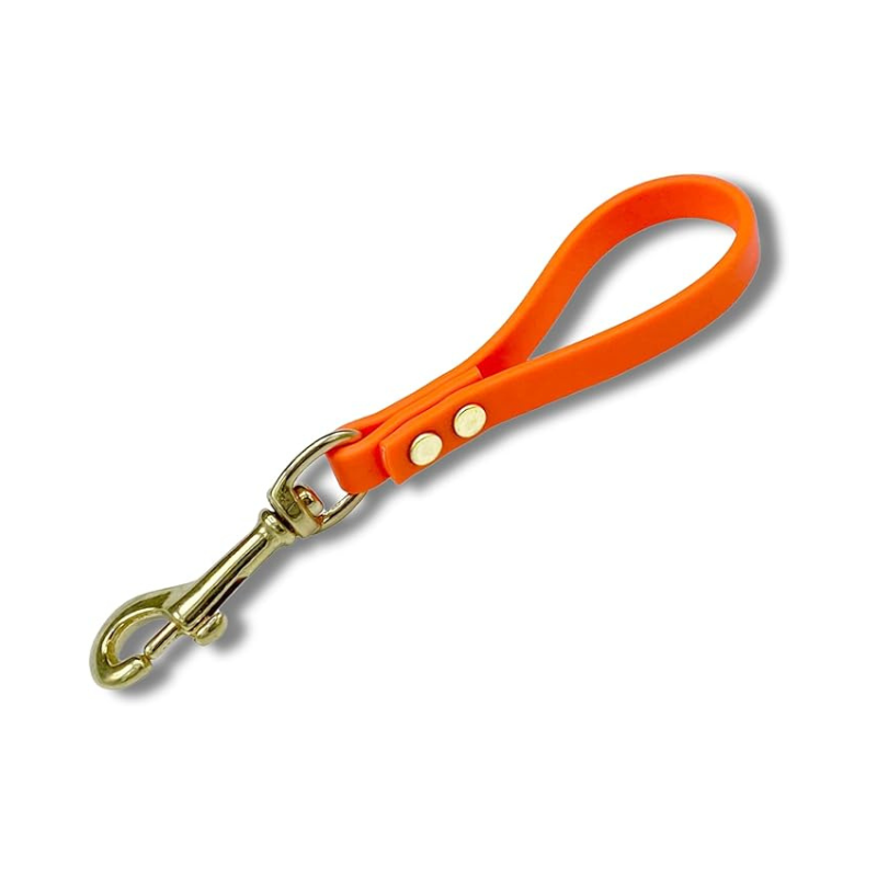 Orange Biothane pull tab for dog training with brass snap hook, durable waterproof design for control and obedience training.